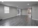 Bright living room with gray laminate floors and neutral walls at 1141 Temperance Ave, Indianapolis, IN 46203