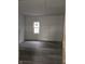 Unfinished bedroom with new vinyl flooring and a window at 1207 W 35Th St, Indianapolis, IN 46208