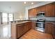 Modern kitchen with stainless steel appliances and hardwood floors at 12689 Bourden Ln, Fishers, IN 46037