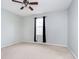 Simple bedroom with carpet, ceiling fan, and window at 1421 E New York St, Indianapolis, IN 46201