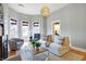 Spacious living room with hardwood floors, large windows, and elegant chandelier at 219 E 10Th St, Indianapolis, IN 46202