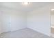 Empty bedroom with grey carpet and a white door at 239 Ambassador Dr, Pittsboro, IN 46167