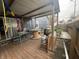 Covered back patio with wooden deck, table, and room for grilling at 323 E Franklin St, Shelbyville, IN 46176
