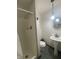 Clean bathroom with shower, pedestal sink, and tiled floor at 323 E Franklin St, Shelbyville, IN 46176