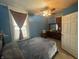 Blue bedroom with a double bed and ceiling fan at 323 E Franklin St, Shelbyville, IN 46176