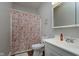 Bathroom with seashell-themed shower curtain, white sink, and medicine cabinet at 330 S Woodward St, Lapel, IN 46051