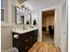 Updated bathroom with a dark wood vanity, white countertop, and a view to the living room at 330 S Woodward St, Lapel, IN 46051