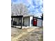 Modern home exterior with a covered porch, red door, and gray siding at 360 S Fleming St, Indianapolis, IN 46241