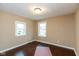 Bright bedroom with hardwood floors and two windows at 3709 Fletcher Ave, Indianapolis, IN 46203