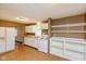 Bright kitchen features white cabinets, wood flooring and an updated stove at 3709 Fletcher Ave, Indianapolis, IN 46203