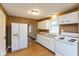 Renovated kitchen boasting white cabinets, wood floors and an open layout at 3709 Fletcher Ave, Indianapolis, IN 46203