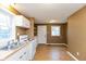 Efficient kitchen with white cabinets, wood-look floors and stainless steel appliances at 3709 Fletcher Ave, Indianapolis, IN 46203