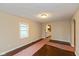 Hardwood floors and fresh paint highlight this open living room with views into the kitchen at 3709 Fletcher Ave, Indianapolis, IN 46203