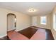 Bright living room with hardwood floors and an arched doorway leading to other rooms at 3709 Fletcher Ave, Indianapolis, IN 46203