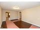 Living room with hardwood floors, an arched entryway, and access to other rooms at 3709 Fletcher Ave, Indianapolis, IN 46203