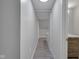 Basement hallway with grey walls and wood-look floors at 501 Madison Ave, Arcadia, IN 46030