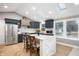 Modern kitchen with navy cabinets, white island, and skylights at 5311 W Jackson St, Muncie, IN 47304