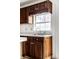 Close-up of the kitchen sink, wood cabinets, and window at 6771 Lexington Cir, Zionsville, IN 46077