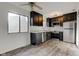Modern kitchen featuring dark cabinetry, stainless steel appliances, and marble countertops at 7909 Benjamin Dr, Indianapolis, IN 46226