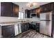 Updated kitchen with dark cabinetry, stainless steel appliances, and marble countertops at 7909 Benjamin Dr, Indianapolis, IN 46226