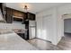 Modern kitchen with stainless steel appliances and dark cabinets at 7909 Benjamin Dr, Indianapolis, IN 46226