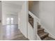 Modern staircase with wood treads and white railings at 7909 Benjamin Dr, Indianapolis, IN 46226