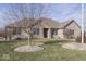Brick home with a manicured lawn and landscaping at 9048 N Watson Meadows Ln, Mooresville, IN 46158