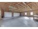 Unfinished garage with concrete floor and double garage doors at 9048 N Watson Meadows Ln, Mooresville, IN 46158