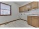 Laundry room with wooden cabinets and a sink at 9048 N Watson Meadows Ln, Mooresville, IN 46158