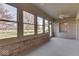 Sunroom with brick walls, carpet, and multiple windows overlooking yard at 9048 N Watson Meadows Ln, Mooresville, IN 46158