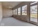 Bright sunroom with brick walls, carpet flooring, and multiple windows at 9048 N Watson Meadows Ln, Mooresville, IN 46158
