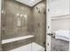 Modern bathroom with a large glass shower, built-in seat, and neutral tile at 1014 Stonehaven Dr, Indianapolis, IN 46239