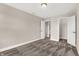Well-lit bedroom with carpet, window, and access to hallway at 1014 Stonehaven Dr, Indianapolis, IN 46239
