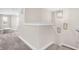 Upstairs hallway with carpet and access to bedrooms at 1014 Stonehaven Dr, Indianapolis, IN 46239