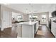 Modern kitchen with white cabinets, island, stainless steel appliances, and hardwood floors at 1014 Stonehaven Dr, Indianapolis, IN 46239