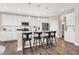Modern kitchen with white cabinets, island, stainless steel appliances, and hardwood floors at 1014 Stonehaven Dr, Indianapolis, IN 46239