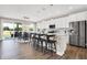 Modern kitchen with white cabinets, island, stainless steel appliances, and hardwood floors at 1014 Stonehaven Dr, Indianapolis, IN 46239