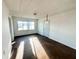 Bright living room with hardwood floors and large windows at 1016 E 29Th St, Anderson, IN 46016