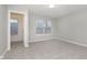 Spacious bedroom with neutral walls and carpet, featuring a large window and walk-in closet at 10620 Sand Creek Blvd, Fishers, IN 46037