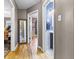 Light-filled hallway with hardwood floors and access to multiple rooms at 1246 N Downey Ave, Indianapolis, IN 46219