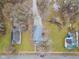 An aerial view of a gray house with a driveway, surrounded by trees and neighboring houses at 2709 Station St, Indianapolis, IN 46218