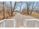 Backyard view with a gravel driveway or parking area, seen from a white deck or porch at 2709 Station St, Indianapolis, IN 46218