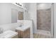 Modern bathroom with double vanity, walk-in shower, and wood-look flooring at 2709 Station St, Indianapolis, IN 46218