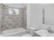 Modern bathroom with gray tiled shower, white vanity, and contemporary fixtures at 2709 Station St, Indianapolis, IN 46218