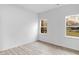 Bright bedroom with wood-look flooring and multiple windows at 2709 Station St, Indianapolis, IN 46218