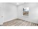 Bright bedroom with large window and wood-look flooring at 2709 Station St, Indianapolis, IN 46218