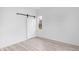 Bright bedroom with a sliding barn door and wood-look flooring at 2709 Station St, Indianapolis, IN 46218