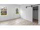 Bright bedroom with sliding barn door closet and wood-look flooring at 2709 Station St, Indianapolis, IN 46218