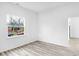 Spacious bedroom with wood-look flooring and a large window at 2709 Station St, Indianapolis, IN 46218