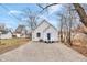 Gravel driveway leading to a gray, single-story home with a blue door at 2709 Station St, Indianapolis, IN 46218